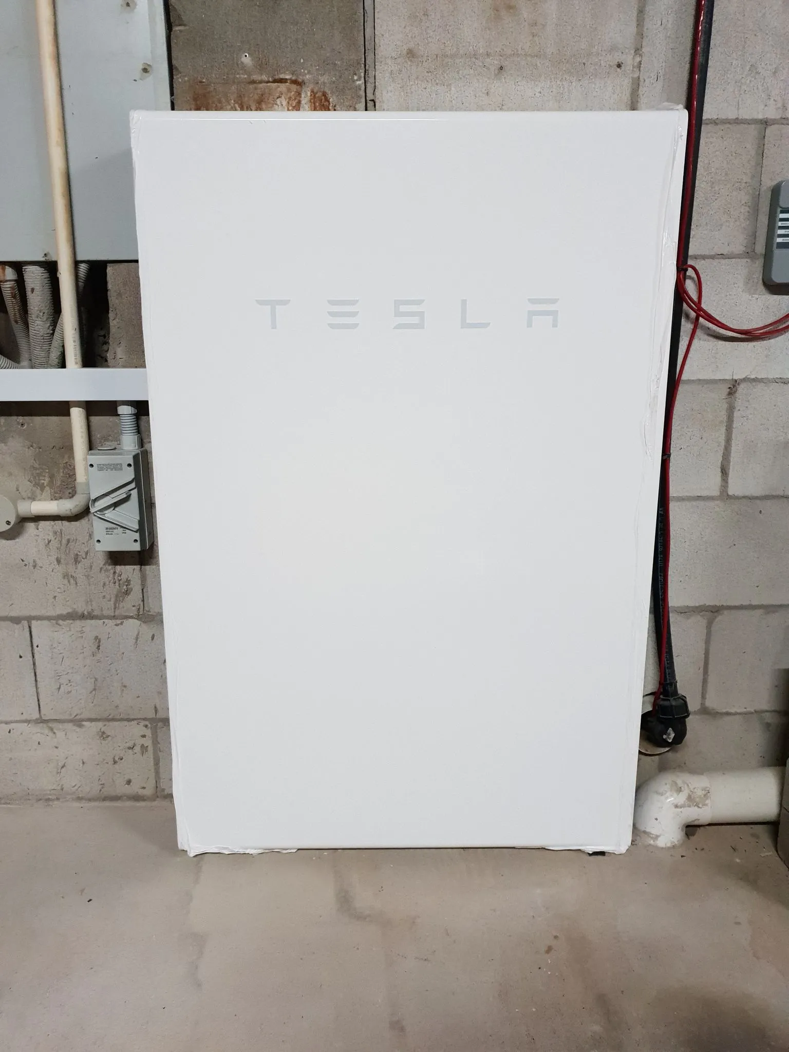 Tesla Powerwall home battery installed by On Point Solar in a Townsville garage