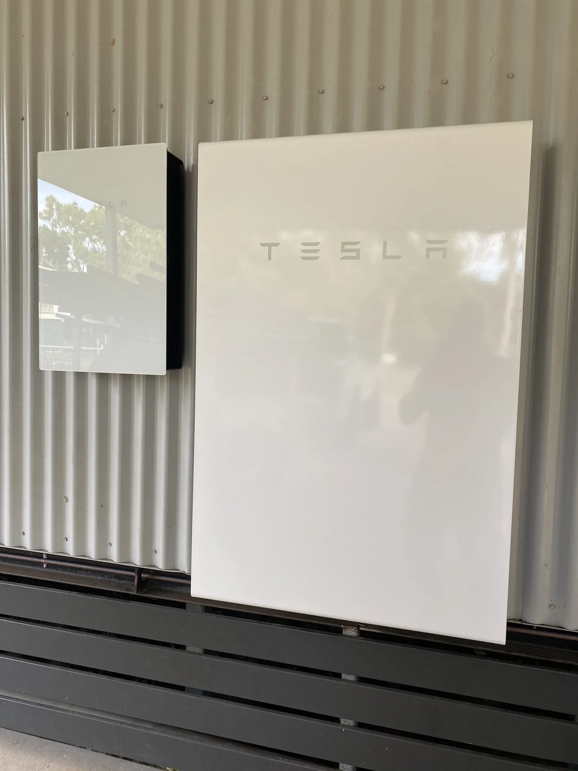 Two Tesla Powerwall batteries installed on a shed wall by On Point Solar in Townsville